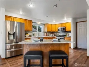 The kitchen has nice granite countertops and a great space for you to eat a casual meal at the bar.