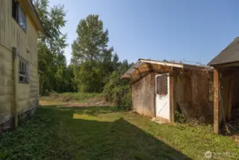 North side of the house, old outbuildings and clearing that leads to the creek.