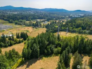 This aerial looks south and east back at the property from the vicinity of the north east corner of the land. The power lines on the left side of this photo are on a road right of way that is also the property line.