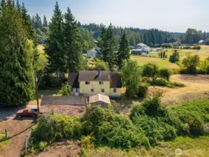 Looking south at the house and past the property. The prolific old orchard is behind the house.