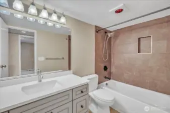 Full Bathroom J&K soft close cabinets, granite counters into newer sink. Notice the tiled surround with a niche around tub!