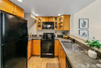 Open kitchen with concrete counters and great storage!