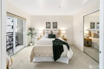 Main floor bedroom with large closet and access to balcony