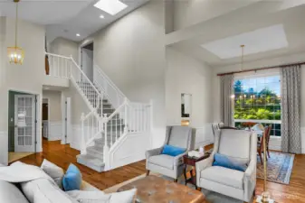 Open High ceiling Living Room with Regal Stairway, perfect for tiered holiday guest photographs.