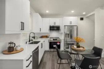 Thoughtfully designed main level with wide plank flooring, stylish lighting, and plenty of space for living and entertaining.