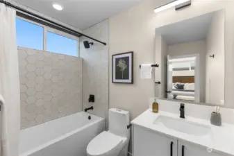 Modern hex tile, matte black finishes, and a deep soaking tub create the ultimate self-care spot. Light some candles, grab your favorite book, and soak your worries away!