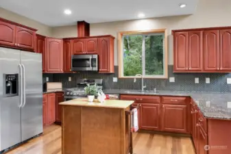 Great kitchen with granite counters & solid cherry cabinets.