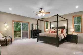 Spacious main floor primary bedroom with deck.