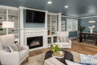 Views of the cozy living room with built-ins flanking the contemporary gas fireplace. Welcome home!