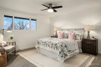 The sizeable primary bedroom offers a prominent window to fill the space with natural light.