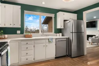 Lovely white cabinets and stainless appliances accompany this open kitchen.