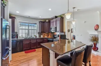 The large peninsula is a plus for those who enjoy cooking or baking. Warm 42" cabinetry topped with crown molding and slab granite counters.