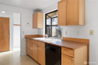 Kitchen features a garden window that looks out to the back yard.