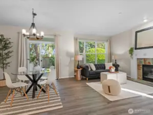 The comfortable dining and living room area with cozy gas fireplace opens to a beautiful fenced back yard.