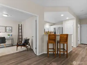 Kitchen opens to main living area with cozy breakfeast bar