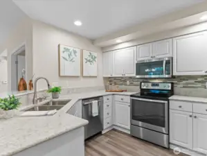 Kitchen has newer quartz counters and stainless steel appliances