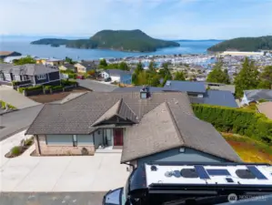Overlooking spectacular Burrows Island and Burrows Bay as well as the Olympics. You can load your RV or boat right from your own driveway and be off on adventures in just minutes! This motorhome is 45' long including the motorcycle lift. There is plenty of room in front for a boat!