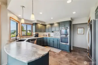 Well designed and planned updated kitchen with leathered granite counters, stainless appliances including refrigerator, double oven and dishwasher. New flooring and windows, even space to enjoy your morning coffee.