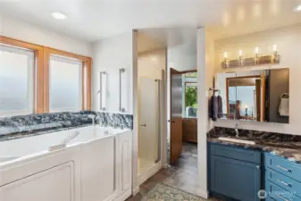 Primary bathroom offers a convenient walk-in jetted tub, plus a walk-in shower.