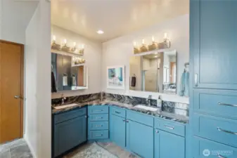 Primary bathroom with granite counters, double sinks, a walk-in jetted tub and a walk-in shower.
