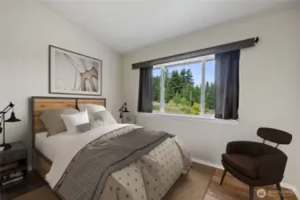 Bedroom #2, located across from the half bath, offers a large closet, a built-in fold-down table, and a lovely view of the beautifully landscaped backyard.