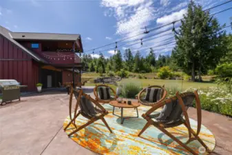 The custom-stamped outdoor patio is perfect for endless entertaining, offering a stylish and durable space for gatherings. A covered patio area beneath the upper-level balcony expands your outdoor living options, providing a sheltered retreat ideal for year-round enjoyment—even during the wet months.
