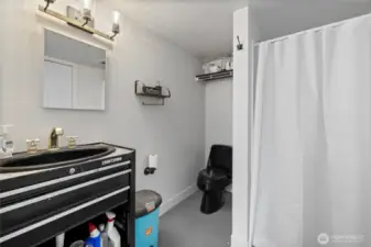Shop bath with custom toolbox vanity and a shower.