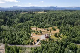An expansive driveway and ample parking provide plenty of space for vehicles, trailers, and guests.