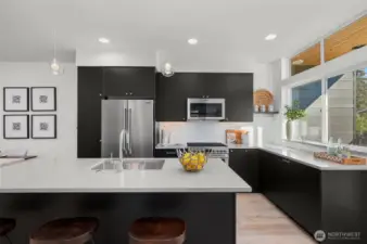 A closer look at the kitchen reveals a harmonious blend of sophistication and practicality. Enjoy the seamless flow of this space, ideal for cooking, entertaining, or simply admiring the thoughtful design. Photos of home with similar layout, finishes & fixtures.