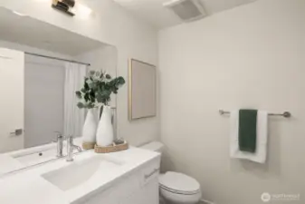 Modern and sleek, this bathroom combines style with functionality. The clean design, complemented by elegant lighting and a spacious vanity, makes it ideal for morning routines and evening relaxation. Photos of home with similar layout, finishes & fixtures.