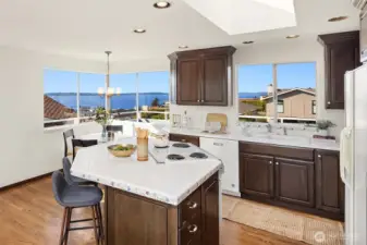 Kitchen with hardwood floors, skylight, island, and amazing views.