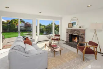 Another living room space with fireplace off the kitchen. Glass door slider leads to the patio.