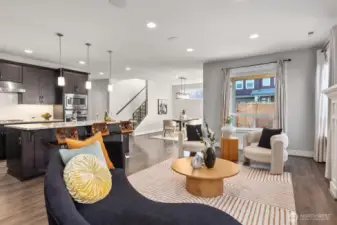 Living room with kitchen and dining room in the background.