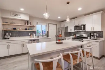 Quartz countertops, SS appliances, soft close cabinets, gas stove/range