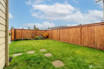 Fully fenced backyard, fresh landscaping