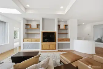 Looking across the living room at the built-ins.  The entry to the primary bedroom is to the left.
