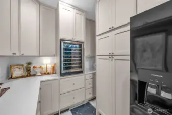 Pantry appliances include a full fridge, wine fridge & in cabinet microwave.