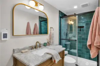 Bathroom #3, with heated floors. A laundry room or small kitchen could also be added to the basement suite for a full MIL experience.