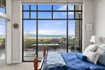 Wake up to breathtaking waterfront views from this serene bedroom retreat. Floor-to-ceiling windows fill the space with natural light and frame stunning views of the Puget Sound, while the private patio just beyond offers the perfect place to relax and enjoy the coastal surroundings.