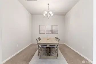 Elegant formal dining room with soaring ceilings, modern chandelier, and neutral tones that complement any décor. This spacious area is perfect for hosting gatherings, dinner parties, or enjoying everyday meals in a bright and refined setting.