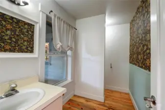 Downstairs powder room is off of the kitchen, adjacent to the laundry area, and doors to exterior and garage access.