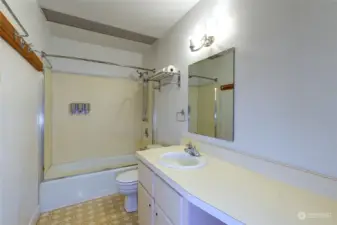 Main bathroom with tub/shower combo.