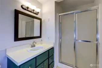 Primary bathroom with walk-in shower.  Claw-foot tub is behind the photographer.