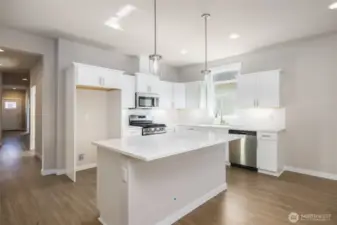 The white kitchen upgraded cabinets w/quartz countertops.