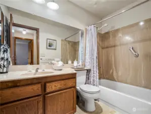 The full guest bathroom is conveniently located just down the hall from the main living space.