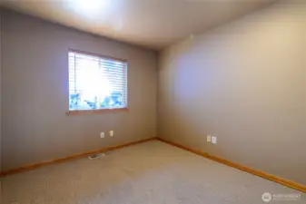 Bedroom #3 with rich wood trim and matching, custom 2" wood blinds.