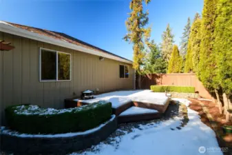 Drought-resistant plants, strategically placed hardscaping create a lush yet easy-to-care-for outdoor space. Whether relaxing on the deck or entertaining guests, this backyard offers both charm and convenience with minimal effort required.