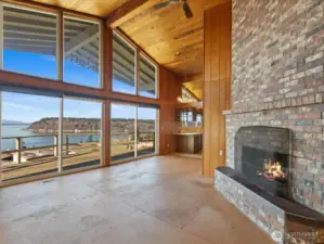 Floor to ceiling windows and fireplace highlight the greatroom's volume