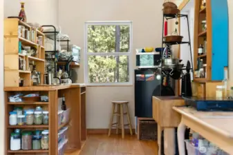 Compact kitchen done right! Hookup for an oven/range is behind the butcher block table on the right, and a regular sized fridge would actually fit between the door and the window!