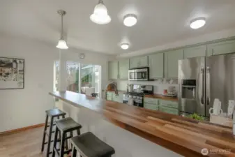 The breakfast bar offers seating for four or more guests—perfect for casual dining or entertaining—and the perfectly fitted bar stools are included with the home!